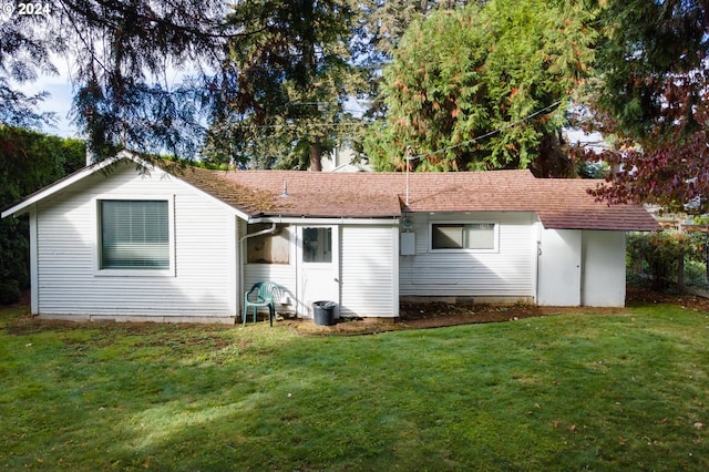 rear view of house with a lawn