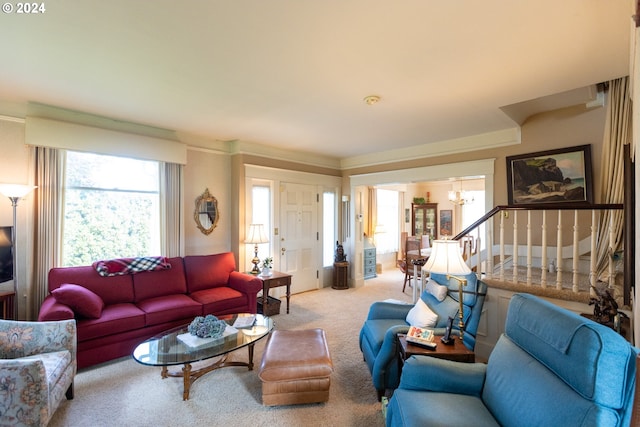 living room featuring a notable chandelier and carpet flooring