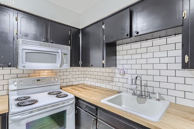 kitchen with tasteful backsplash, sink, white appliances, and butcher block counters