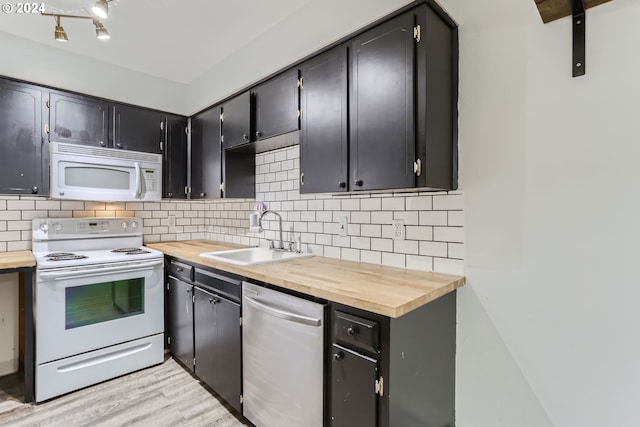 kitchen featuring sink, backsplash, wooden counters, white appliances, and light hardwood / wood-style flooring