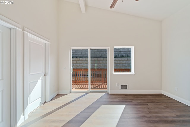 empty room featuring ceiling fan, beam ceiling, wood-type flooring, and high vaulted ceiling