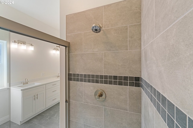 bathroom with vanity and a tile shower