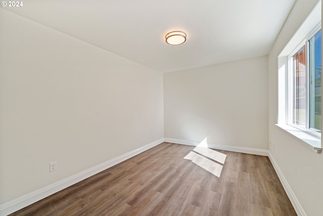 spare room featuring light hardwood / wood-style floors