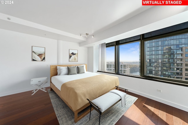 bedroom with dark wood-type flooring