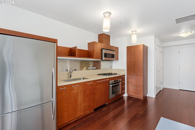 kitchen featuring dark hardwood / wood-style flooring, stainless steel appliances, and sink