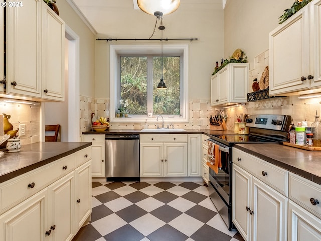 kitchen with appliances with stainless steel finishes, decorative light fixtures, tasteful backsplash, and sink