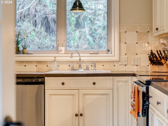 kitchen with white cabinets, sink, appliances with stainless steel finishes, and tasteful backsplash