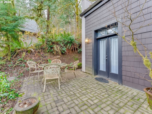 71465 Northshore Dr, Birkenfeld, OR 97016 - doorway to property with a patio, outdoor dining area, and french doors