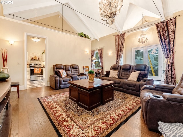 living room with beam ceiling, an inviting chandelier, hardwood / wood-style flooring, and high vaulted ceiling