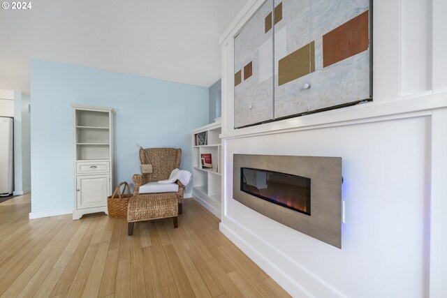 340 SW S Point St, Depoe Bay, OR 97341 - living area with light wood finished floors, a glass covered fireplace, and built in features
