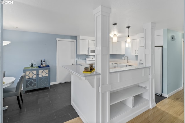 340 SW S Point St, Depoe Bay, OR 97341 - kitchen with white microwave, white cabinets, ornate columns, open shelves, and hanging light fixtures
