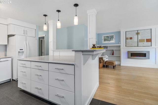340 SW S Point St, Depoe Bay, OR 97341 - kitchen with white appliances, white cabinetry, pendant lighting, wood finished floors, and ornate columns