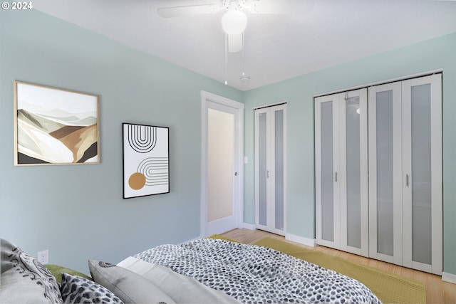 340 SW S Point St, Depoe Bay, OR 97341 - bedroom featuring two closets, wood finished floors, and a ceiling fan