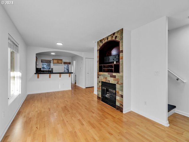 unfurnished living room featuring a fireplace and light wood-type flooring