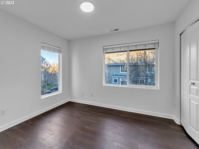 unfurnished room featuring dark hardwood / wood-style floors