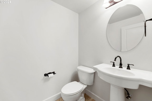 bathroom with toilet and tile patterned floors