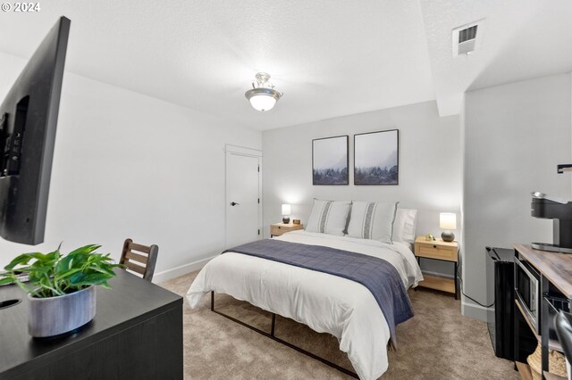 bedroom with light carpet