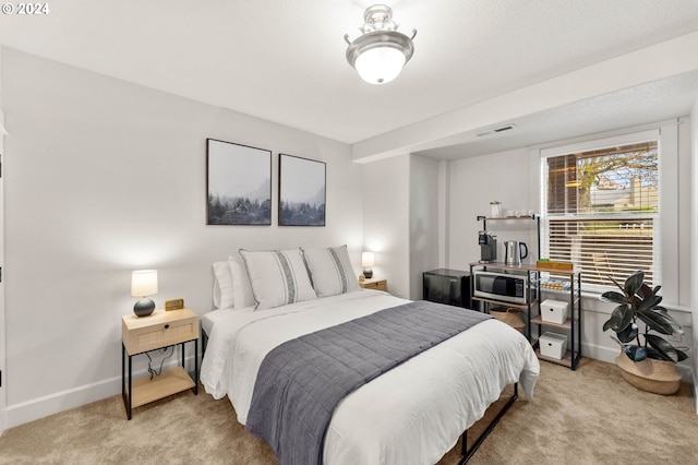 bedroom featuring light carpet