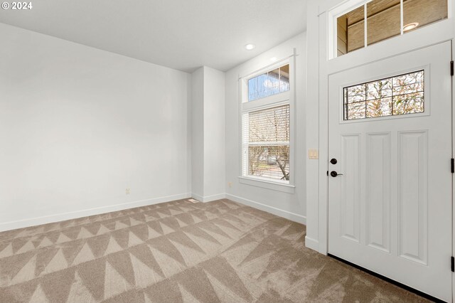 carpeted foyer with plenty of natural light