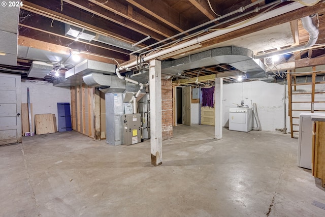 basement featuring washer / clothes dryer and heating unit