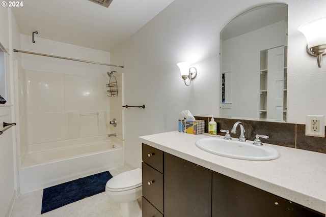 full bathroom with shower / tub combination, vanity, tile patterned floors, and toilet