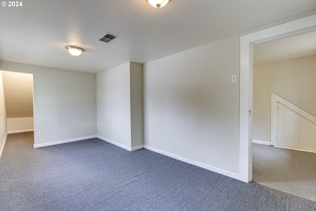 empty room featuring dark carpet