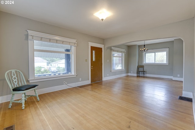 foyer featuring a notable chandelier and light wood-type flooring