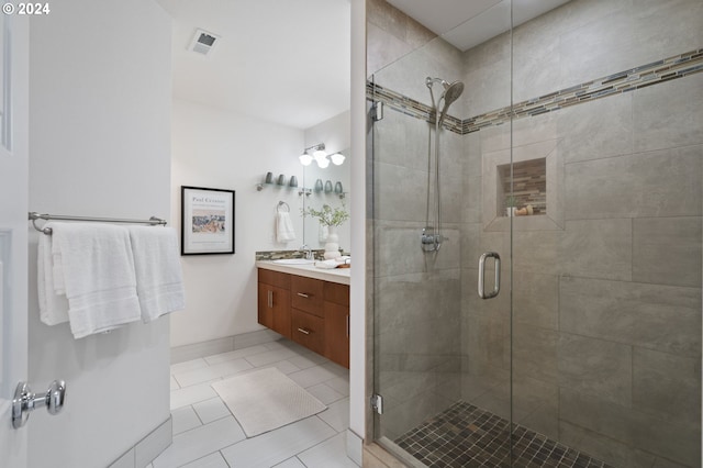 bathroom with vanity, tile patterned floors, and a shower with shower door