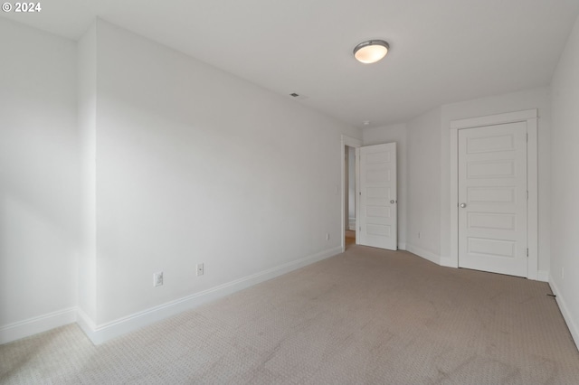 unfurnished bedroom with a closet and carpet flooring