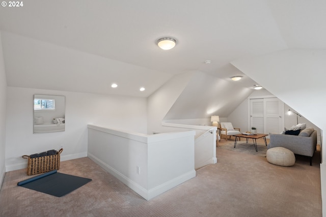 additional living space with vaulted ceiling and light colored carpet