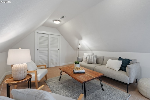 living room with lofted ceiling and a textured ceiling