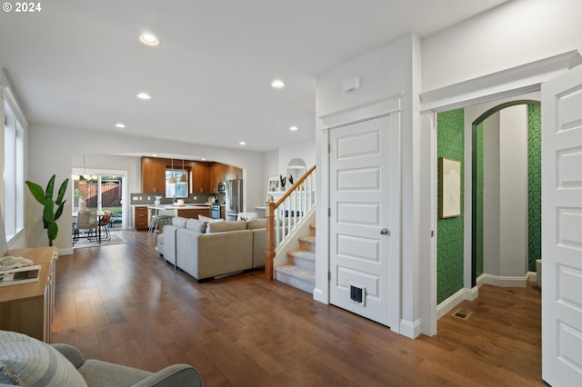 living room with dark hardwood / wood-style flooring