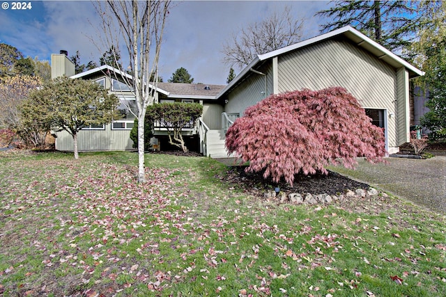 view of side of property with a yard