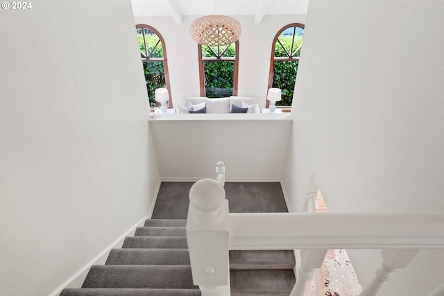 stairs featuring plenty of natural light and beam ceiling