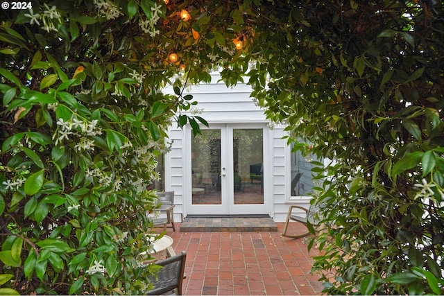 property entrance featuring a patio and french doors