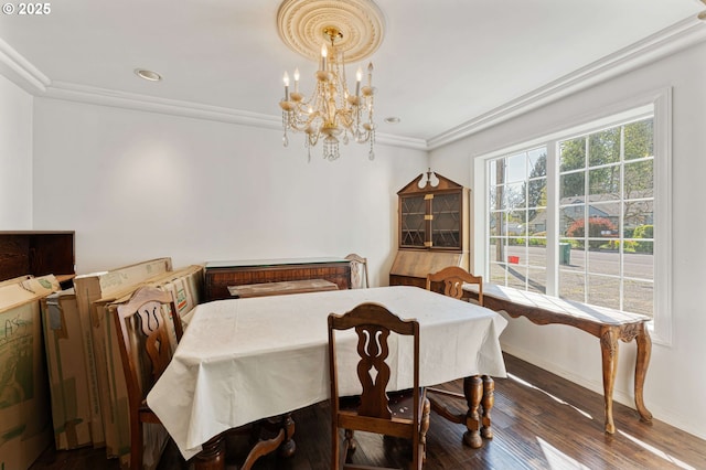 dining space featuring crown molding, wood finished floors, a chandelier, baseboards, and recessed lighting