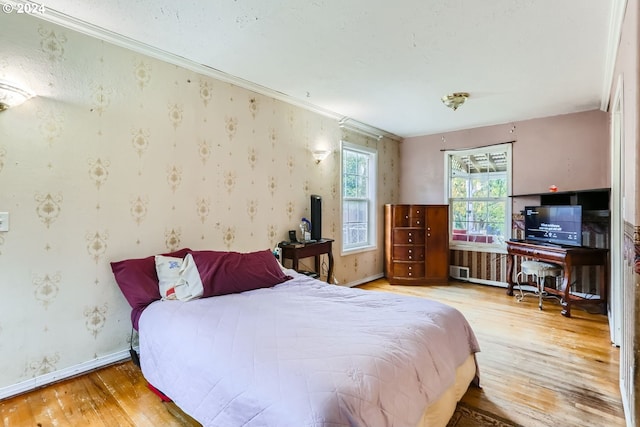 bedroom featuring hardwood / wood-style floors and ornamental molding