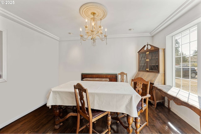 dining space featuring baseboards, crown molding, hardwood / wood-style flooring, and a notable chandelier