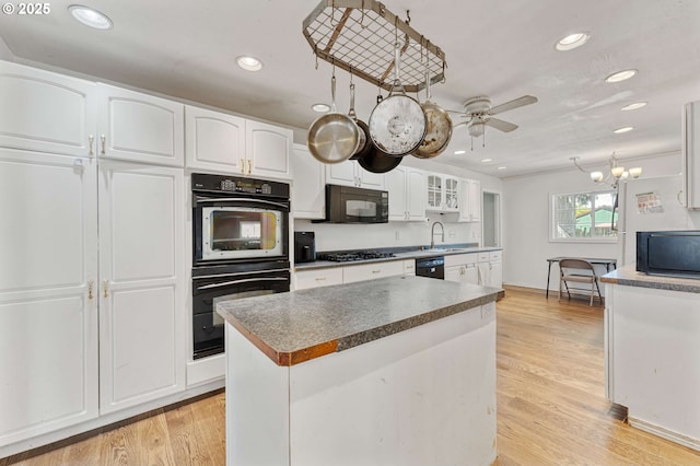kitchen featuring recessed lighting, white cabinets, a ceiling fan, black appliances, and light wood-style flooring