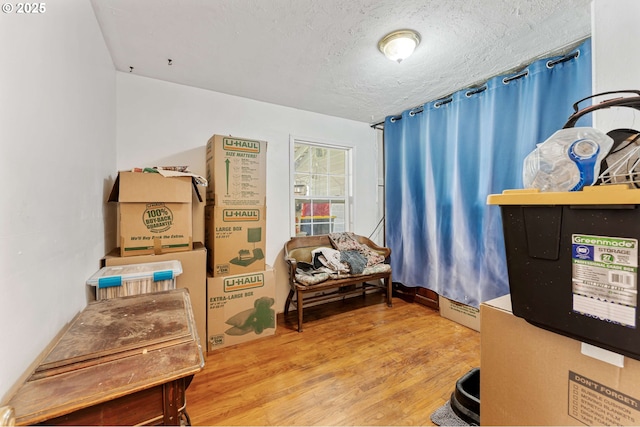 miscellaneous room featuring wood finished floors and a textured ceiling