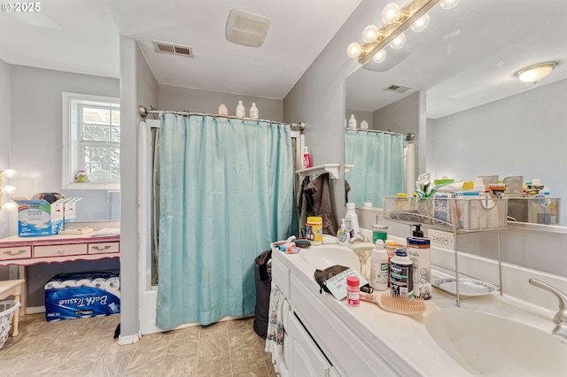 bathroom with a shower with curtain, vanity, and visible vents
