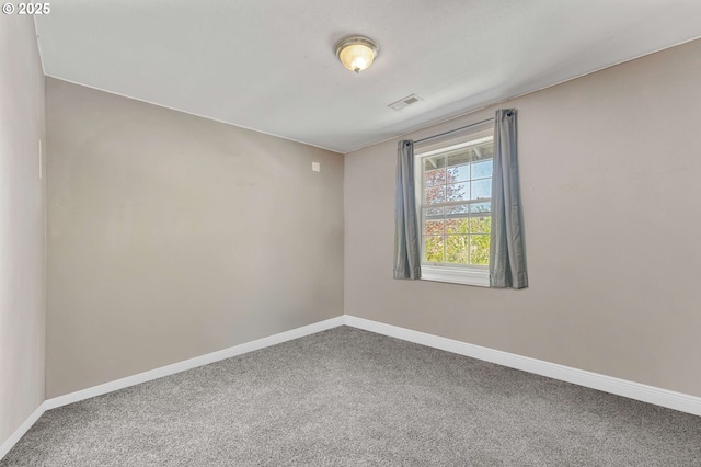 unfurnished room with baseboards, visible vents, and carpet