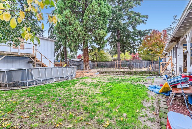 view of yard featuring a fenced in pool and fence