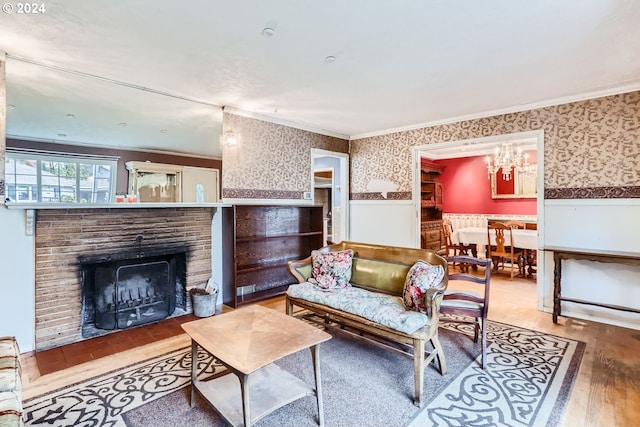 living room featuring a brick fireplace, hardwood / wood-style flooring, and ornamental molding