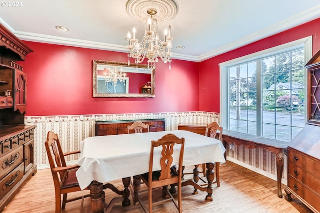 dining area with a chandelier, hardwood / wood-style flooring, and crown molding