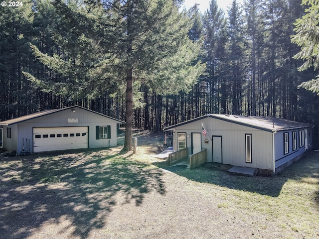 exterior space featuring a yard, an outbuilding, and a garage