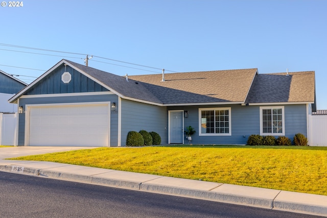 ranch-style home with a garage and a front yard