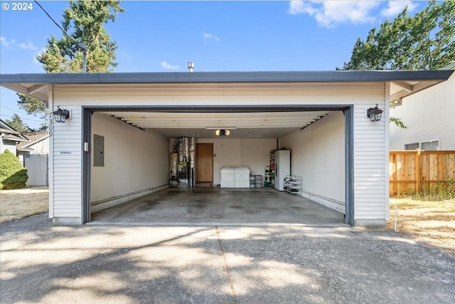 garage featuring electric panel, gas water heater, water heater, and a garage door opener