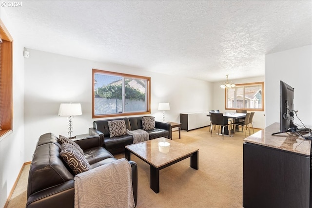 carpeted living room with a textured ceiling and a chandelier