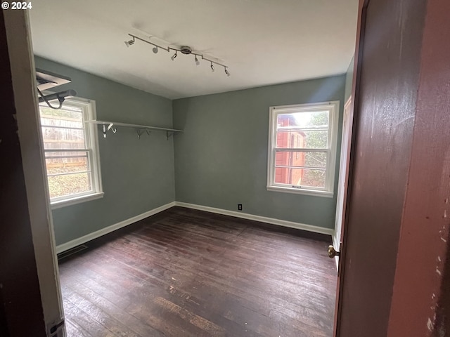 spare room featuring dark hardwood / wood-style floors and a wealth of natural light